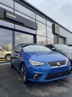 Blue SEAT car outside dealership with signage in background.jpeg