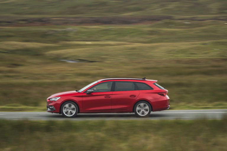 Red SEAT Leon estate on a country road
