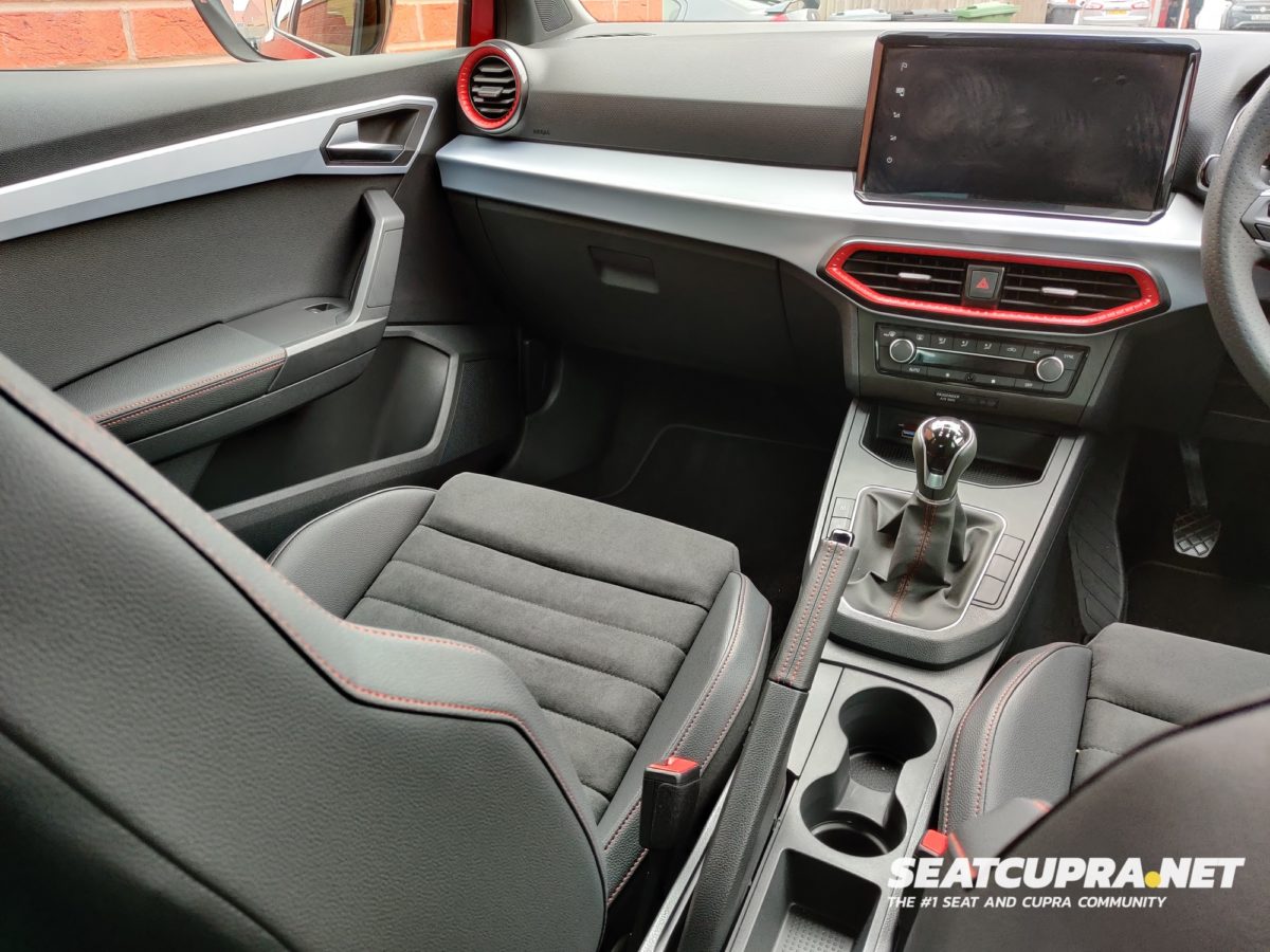 Interior of the Red SEAT Ibiza FR Sport from the back seat looking forwards