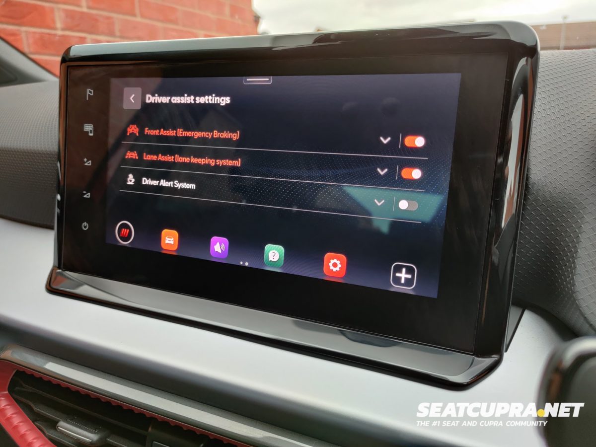 A close up of the infotainment unit showing the driver assist settings (Front Assist and Lane assist with Driver Alert System turned off)