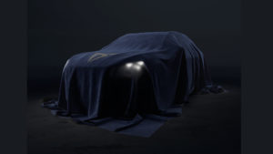 A car under a blanket with the CUPRA Logo on it - the headlights are showing through