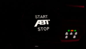 An ABT Start stop button lit in the dark