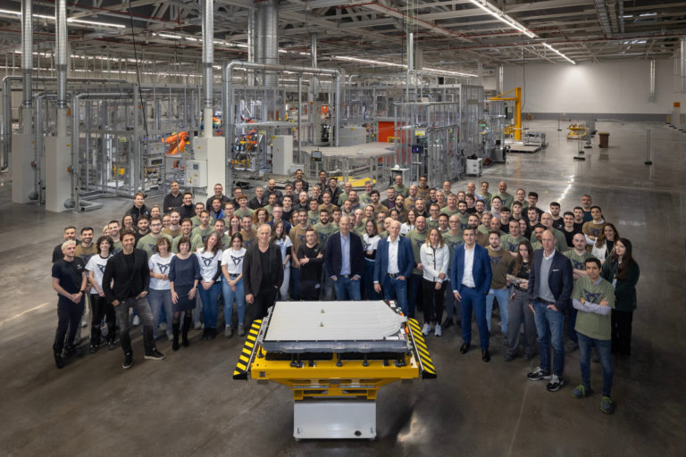 SEAT Factory staff stood in front of a battery for a car