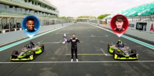 Mr Beast holding a flag next to two CUPRA Formula E cars on a racetrack starting line